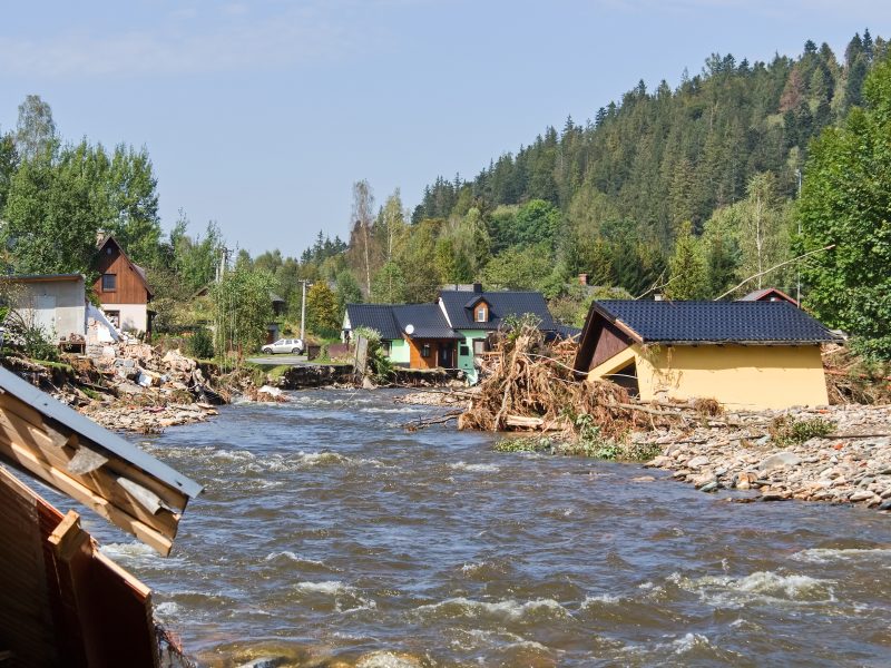 flood damaged houses by a river
