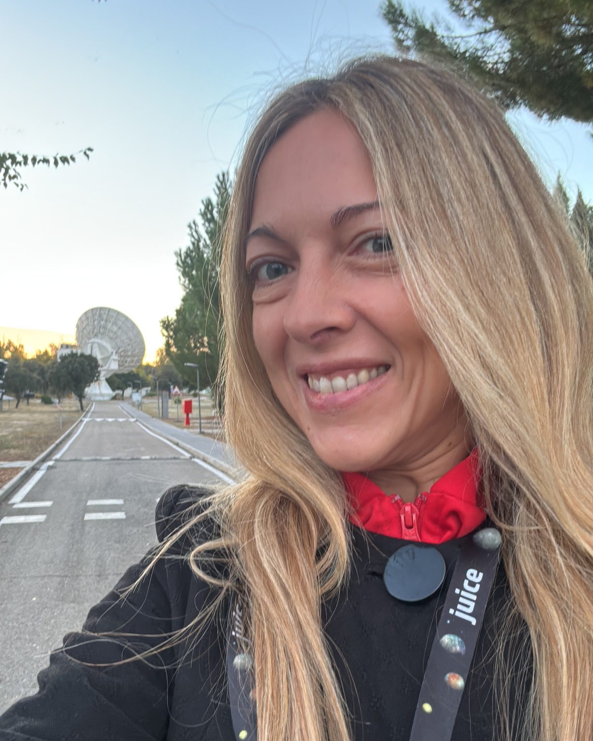 Head and shoulders photo of Pilar from Starion in front of a space antenna