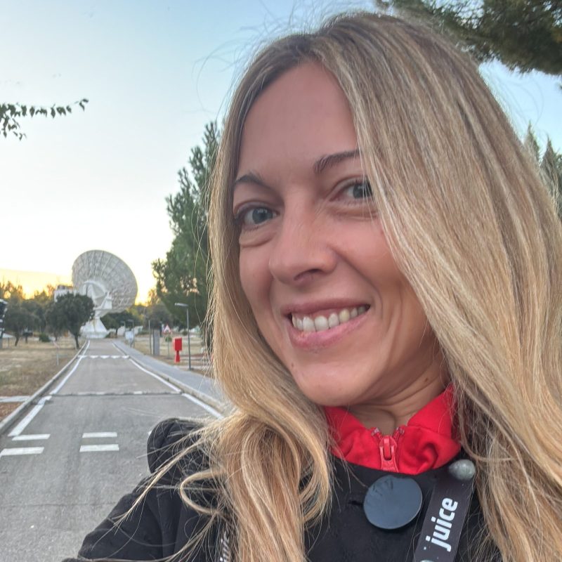 Head and shoulders photo of Pilar from Starion in front of a space antenna